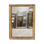 Tara Shaw 19th century French Louis XVI gilded mirror with neoclassical carved frame and elegant aged patina.