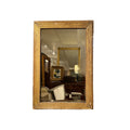 Tara Shaw 19th century French Louis XVI small giltwood mirror with neoclassical carved details and aged patina.