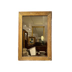 Tara Shaw 19th century French Louis XVI small giltwood mirror with neoclassical carved details and aged patina.
