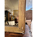 Tara Shaw 19th-century French Louis XVI giltwood mirror with detailed carved frame and aged gold patina.