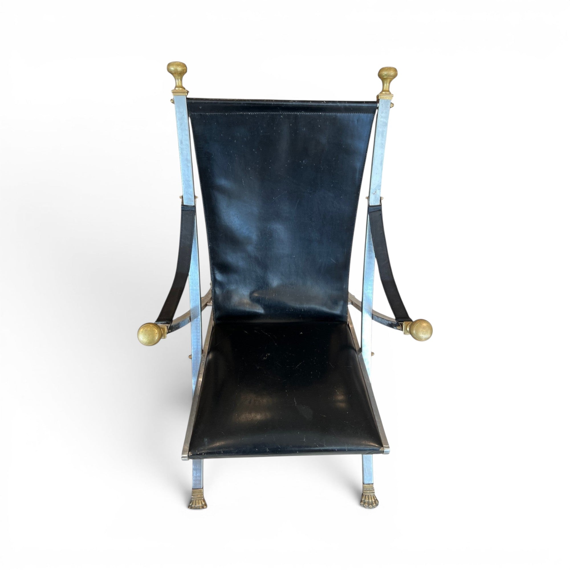 Tara Shaw vintage Maison Jansen folding chair with black leather seat and brass-toned metal frame details.