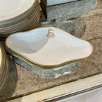 Tara Shaw French china dish with gold rim and elegant monogrammed B detail on a stone surface