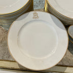 Tara Shaw French china plate featuring a gold monogrammed B and a delicate gold rim on a white porcelain surface.