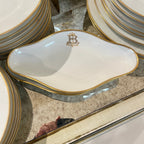 Tara Shaw French china service dish featuring a gold monogrammed B and elegant gold rim on white porcelain