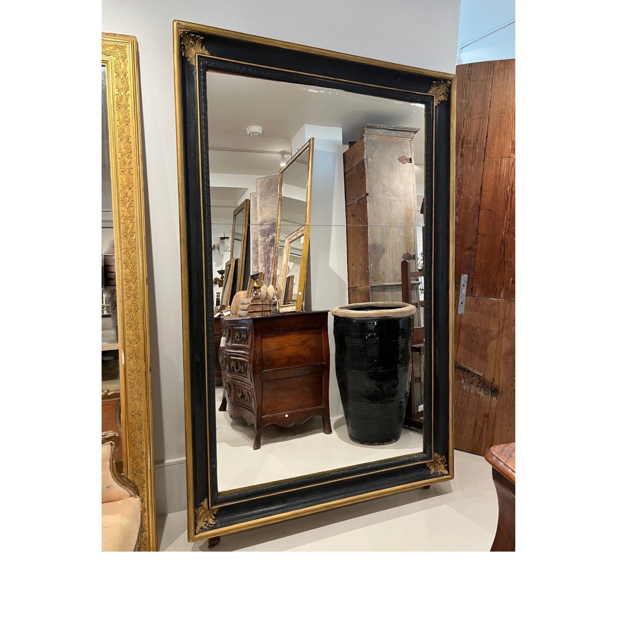 Tara Shaw 19th century French Napoleon III floor mirror with a black and gilt frame and ornate corner detailing.