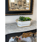 Tara Shaw 19th century European white porcelain jardiniere with gold gilt accents on a marble console table.