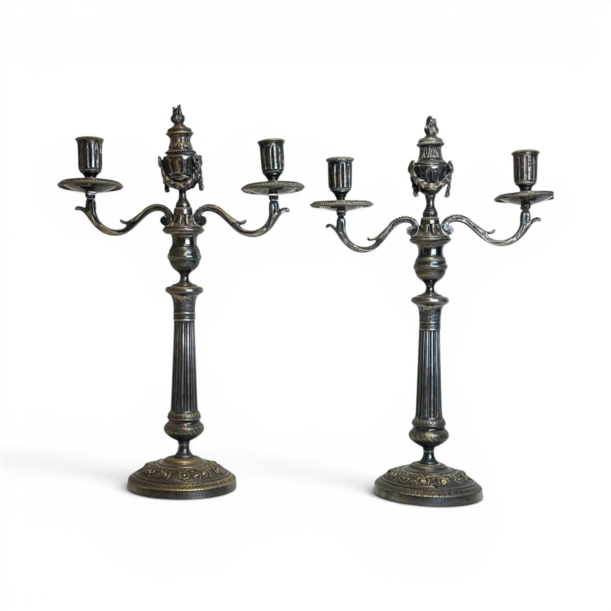 Tara Shaw pair of silver-plated double candlesticks featuring elegant fluted columns and decorative articulating swags.
