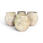 Tara Shaw set of four 18th-century Spanish rustic pottery jars with weathered patina and unique handcrafted textures.