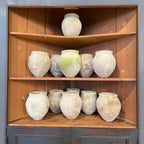 Tara Shaw set of three 18th century Spanish rustic pottery jars with weathered patina displayed on wooden shelves