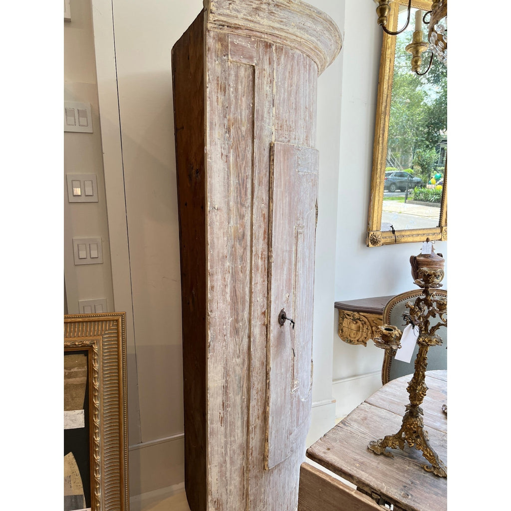 Tara Shaw 18th century Swedish Baroque corner cabinet in solid wood with a distressed white patina and curved door.