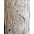 Tara Shaw 18th century Swedish Baroque corner cabinet featuring a distressed wood finish and arched door detail