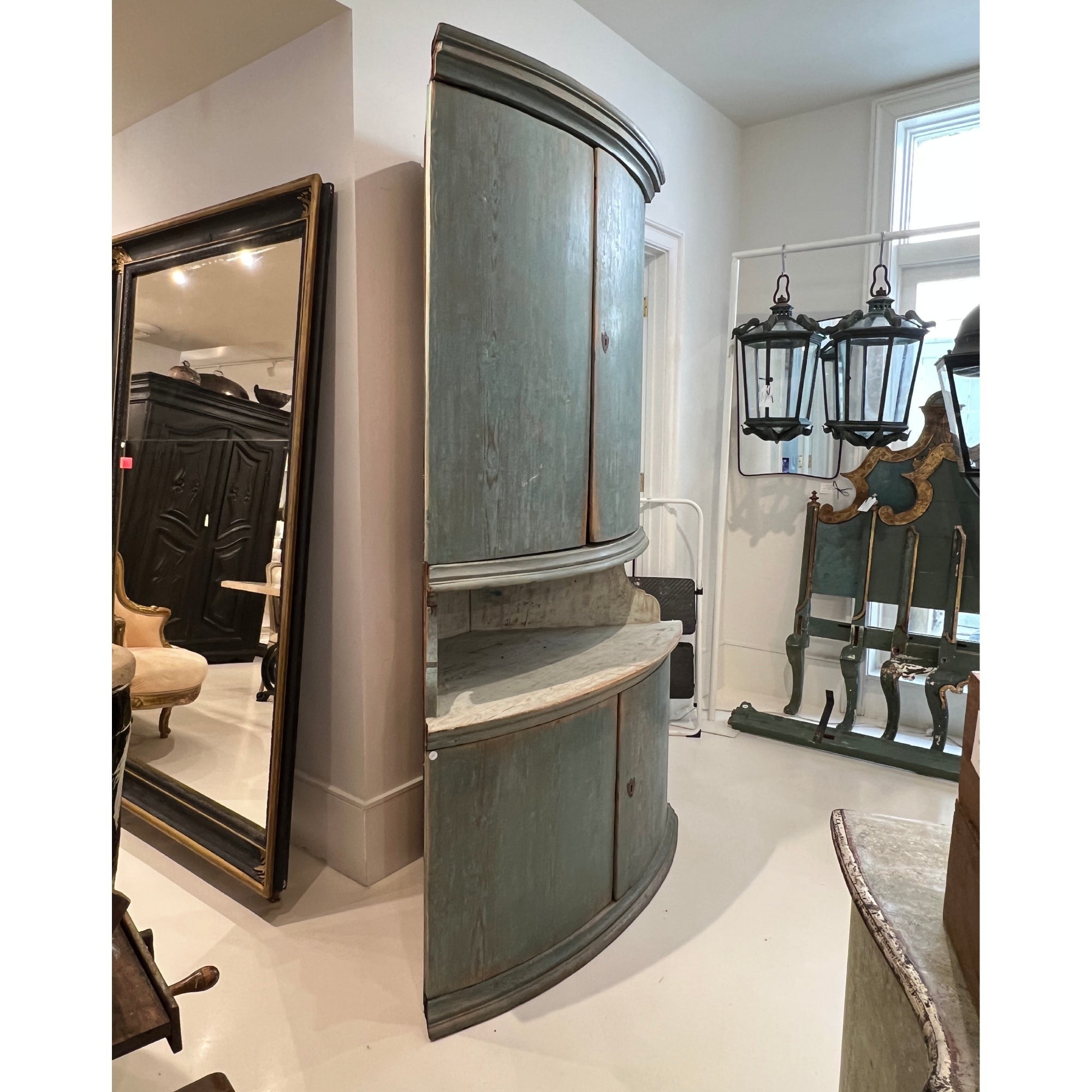 Tara Shaw 19th-century Swedish corner cabinet in aged blue paint with curved doors and elegant Scandinavian design.