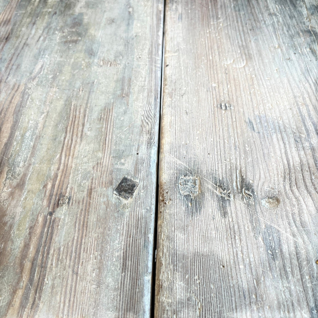 Tara Shaw 19th century Swedish drop leaf table surface with a weathered grey painted wood finish and visible grain.
