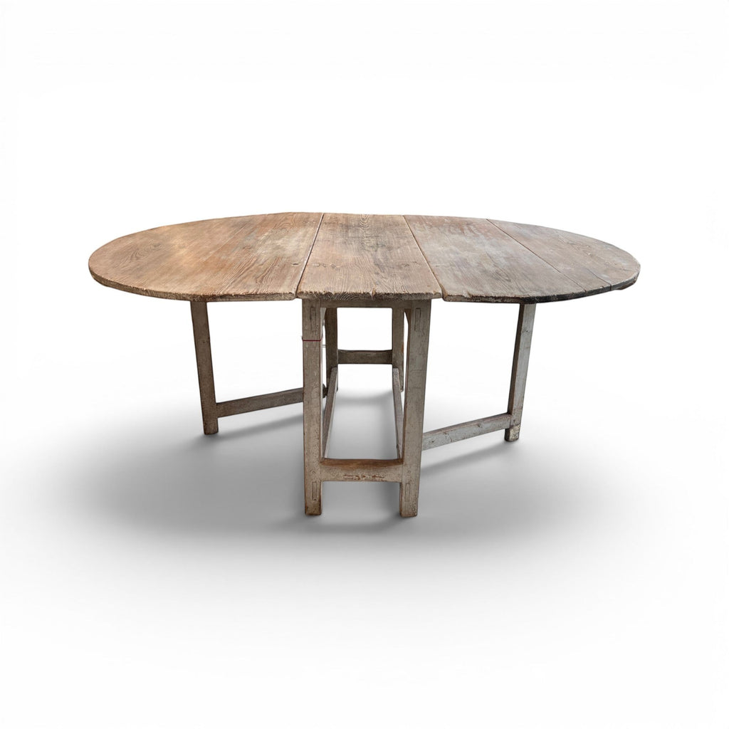 Tara Shaw 19th-century Swedish drop leaf table with a weathered grey painted finish and rustic wooden tabletop.