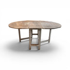 Tara Shaw 19th-century Swedish drop leaf table with a weathered grey painted finish and rustic wooden tabletop.