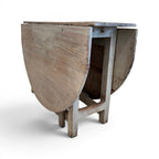 Tara Shaw 19th-century Swedish drop leaf table with a weathered grey painted finish and natural wood grain top.
