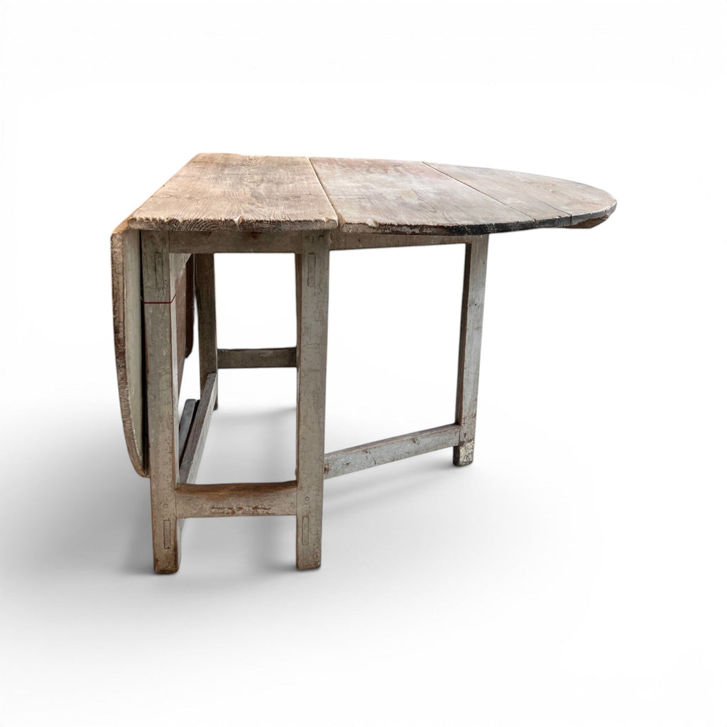 Tara Shaw 19th-century Swedish drop leaf table with a distressed grey painted finish and timeworn wooden surface.