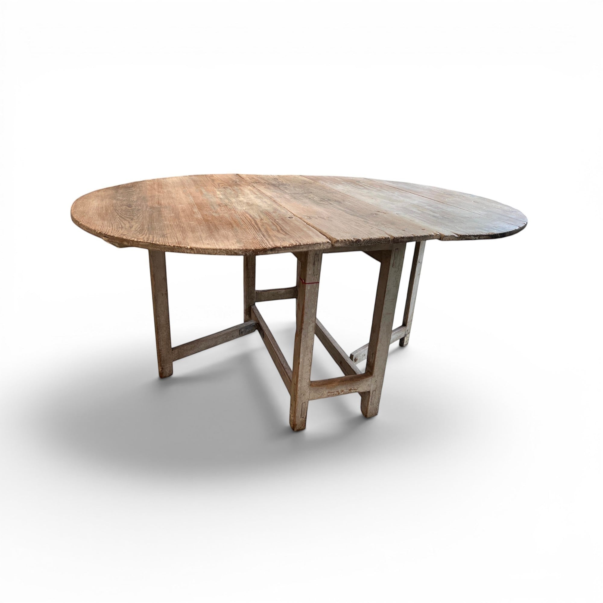 Tara Shaw 19th-century Swedish drop leaf table with a weathered grey painted finish and rustic wooden top.