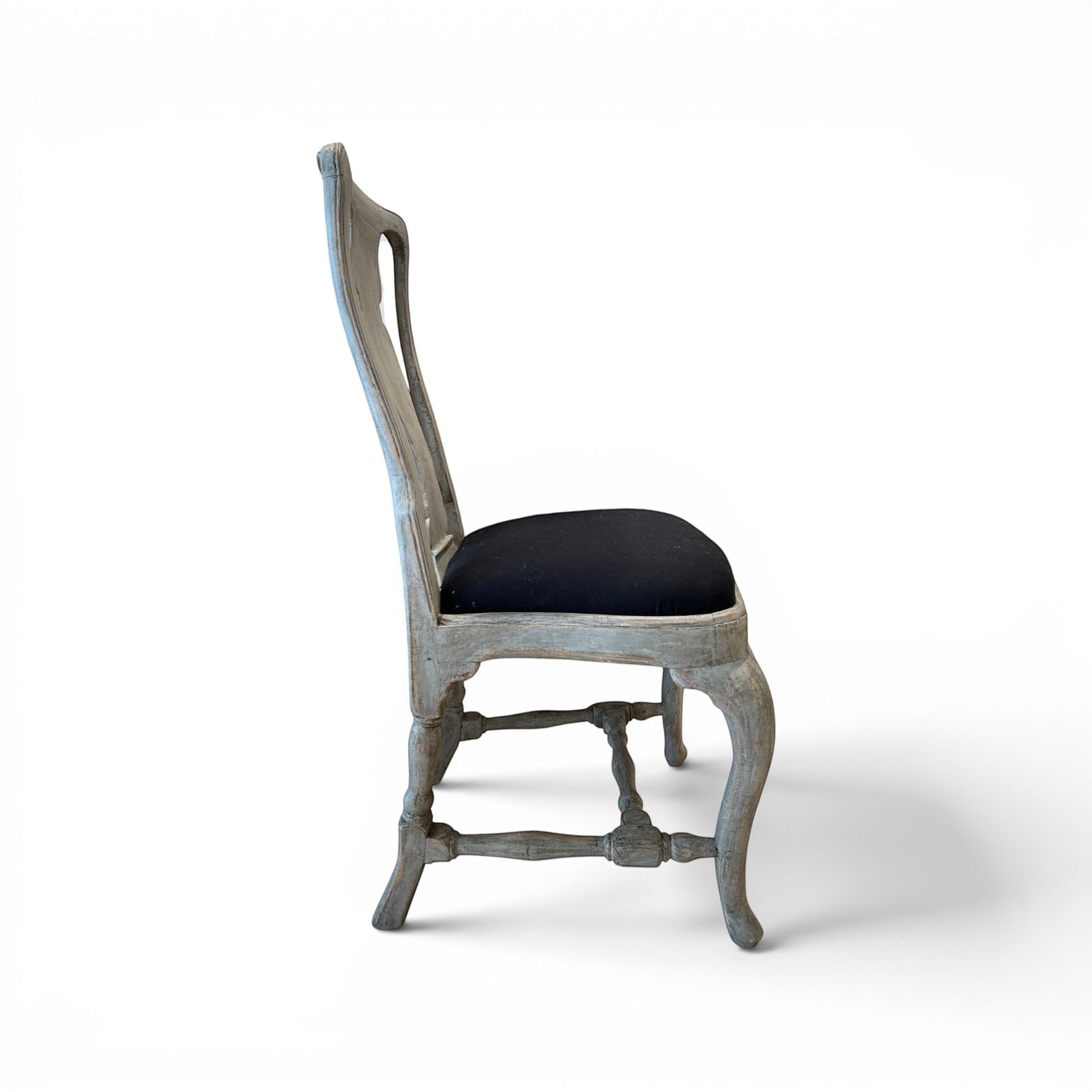 Tara Shaw 18th century Swedish Rococo dining chair with aged grey wood finish and black upholstered seat, side view.