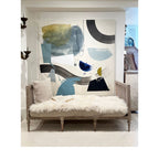 Tara Shaw ivory Tibetan lambskin throw draped over a vintage wooden bench with a plush, organic texture.
