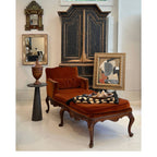 Tara Shaw 18th-century Venetian walnut chaise with rich rust-colored velvet upholstery and ornate carved wood frame.